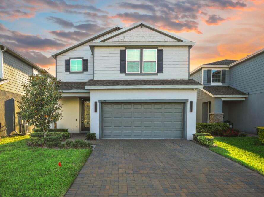 house with garage, highlighting the importance of a certified land surveyor