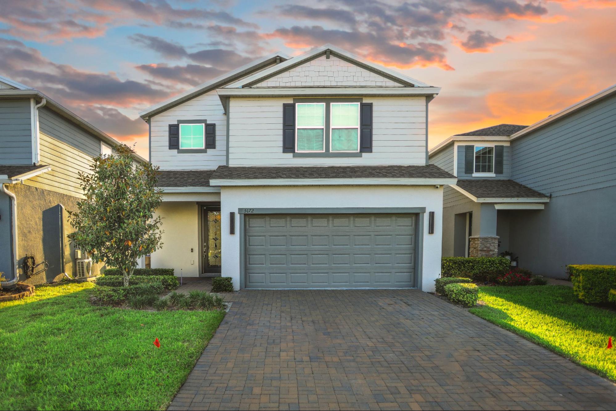 house with garage, highlighting the importance of a certified land surveyor