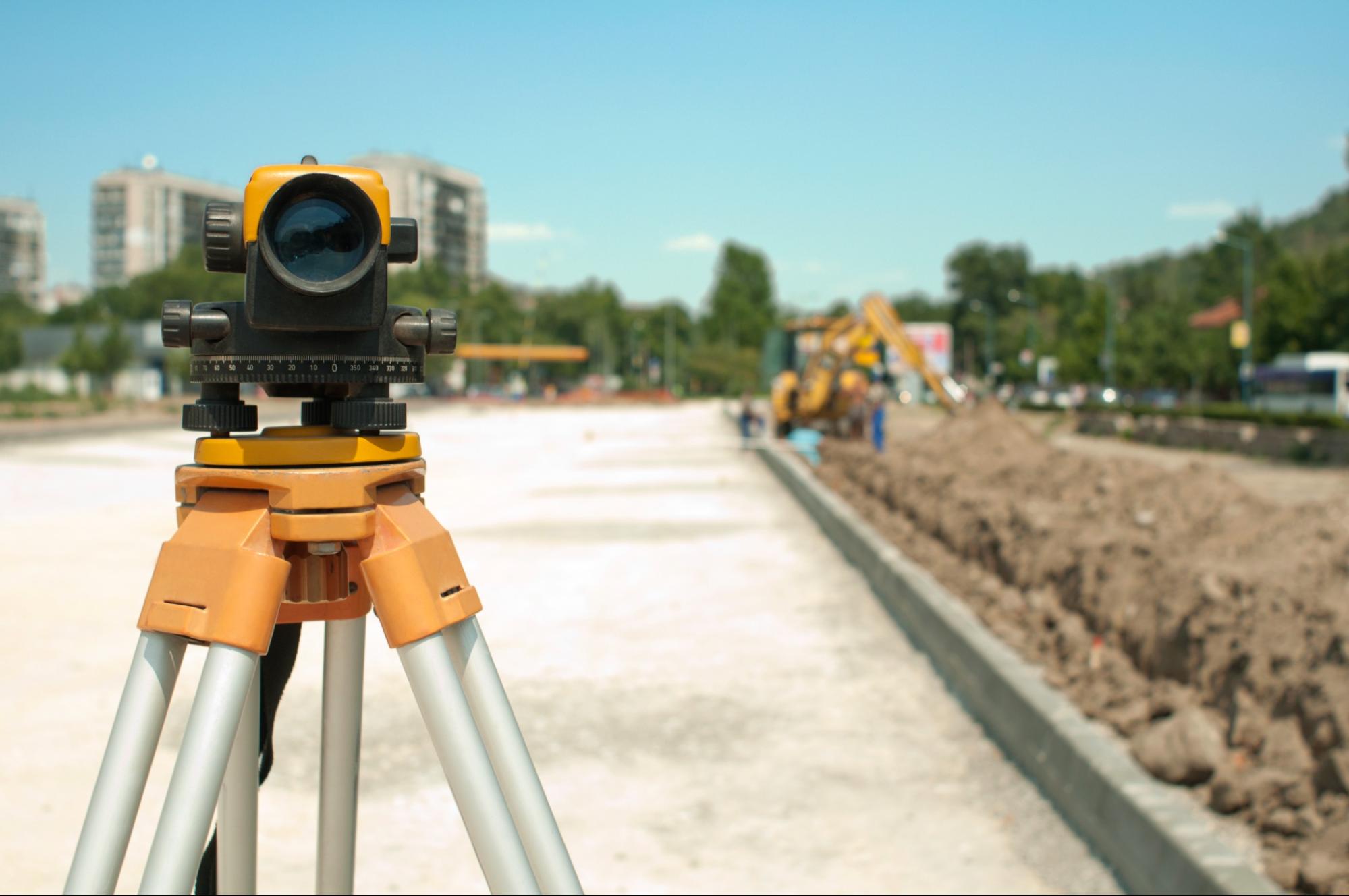 Surveying instrument positioned on roadwork site