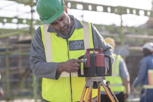 person using surveying equipment