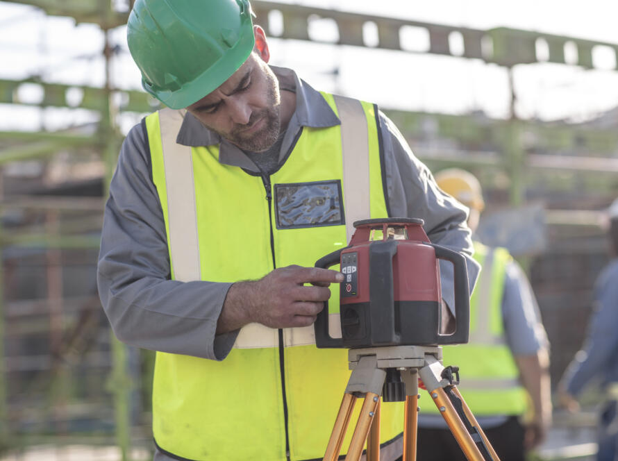 person using surveying equipment