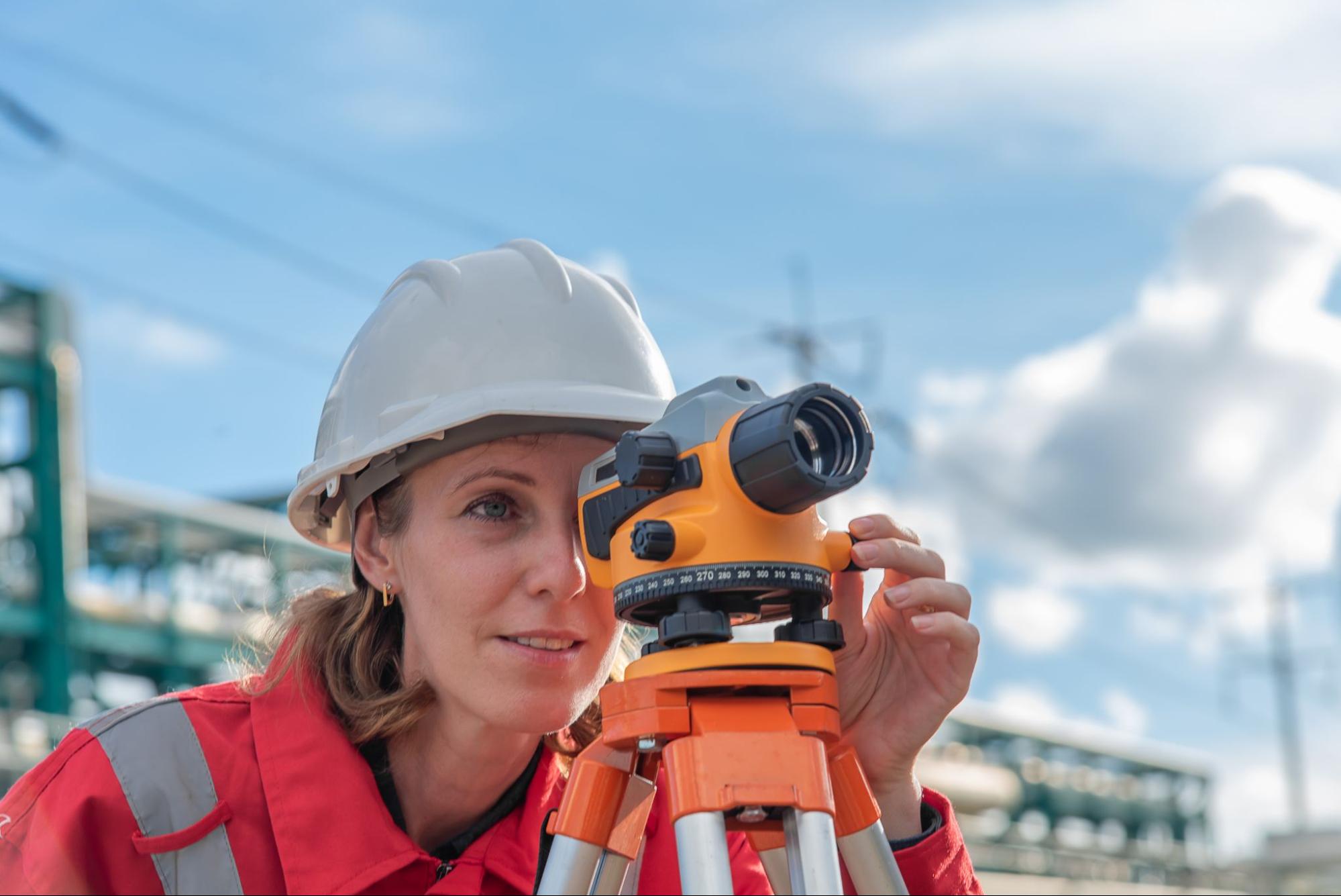 woman using land surveying equipment