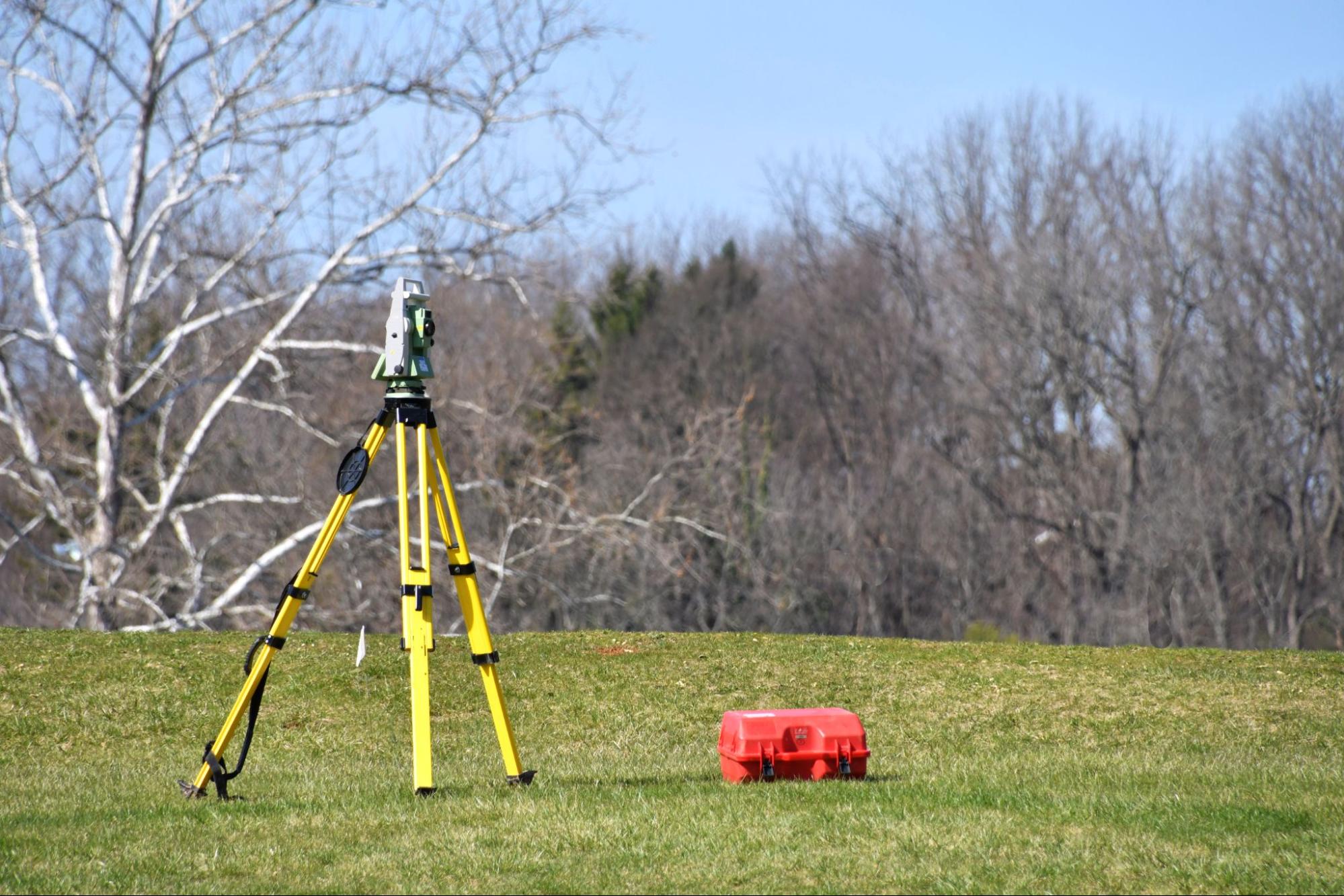 surveying equipment on tripod measuring land boundaries for how to book land surveying services guide