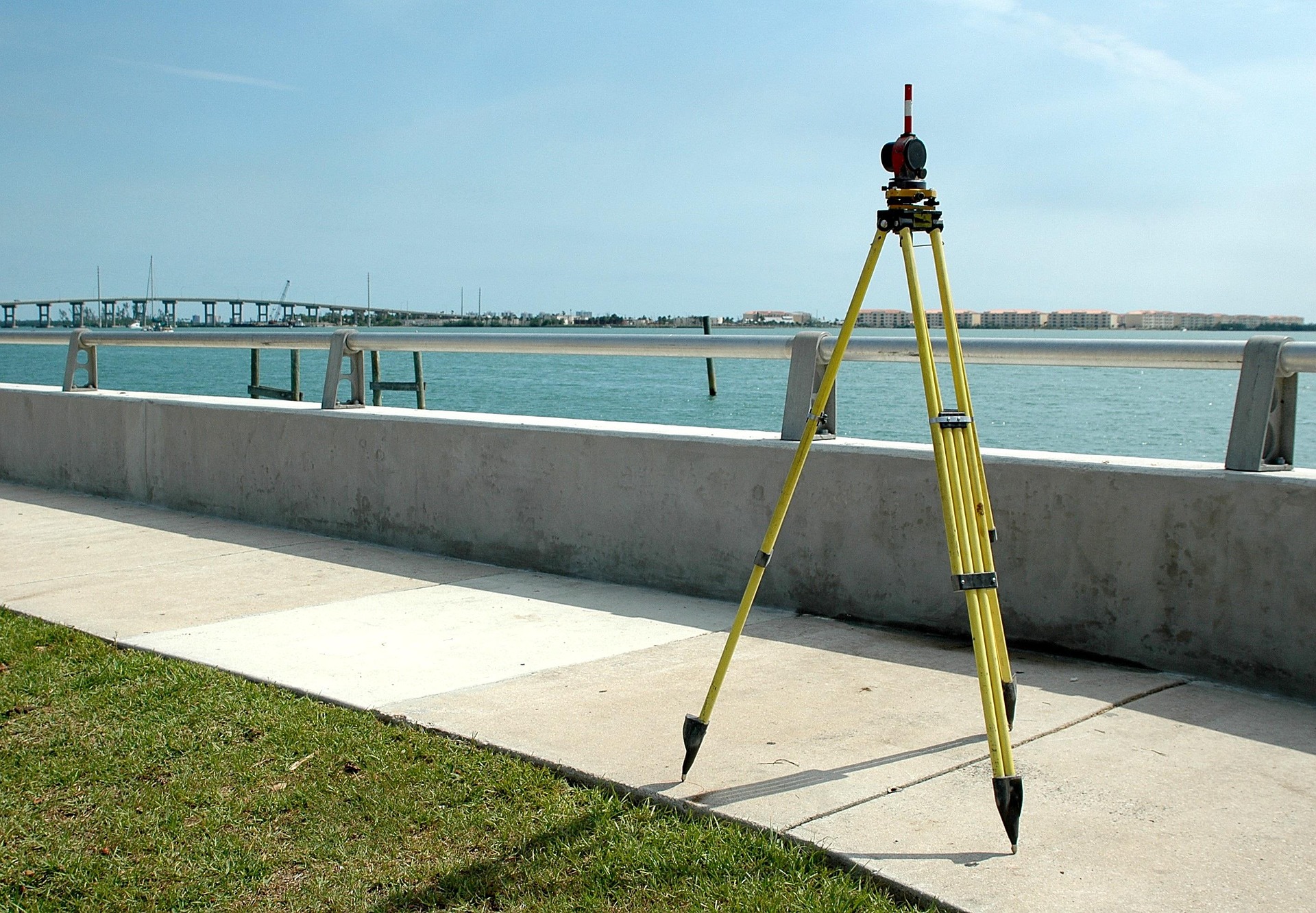 Land surveying tripod and instrument near waterfront property for clients who need to find a land surveyor in South Texas.
