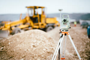 Surveyor equipment GPS system or theodolite outdoors at highway construction site. Surveyor engineering with total station, representing Southpoint Geodetics Address