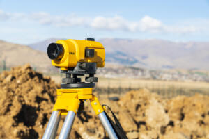 theodolite or total positioning station representing the need to request land survey today