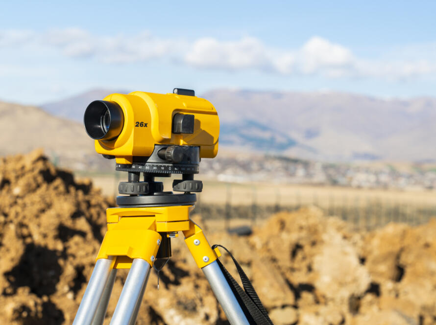 theodolite or total positioning station representing the need to request land survey today