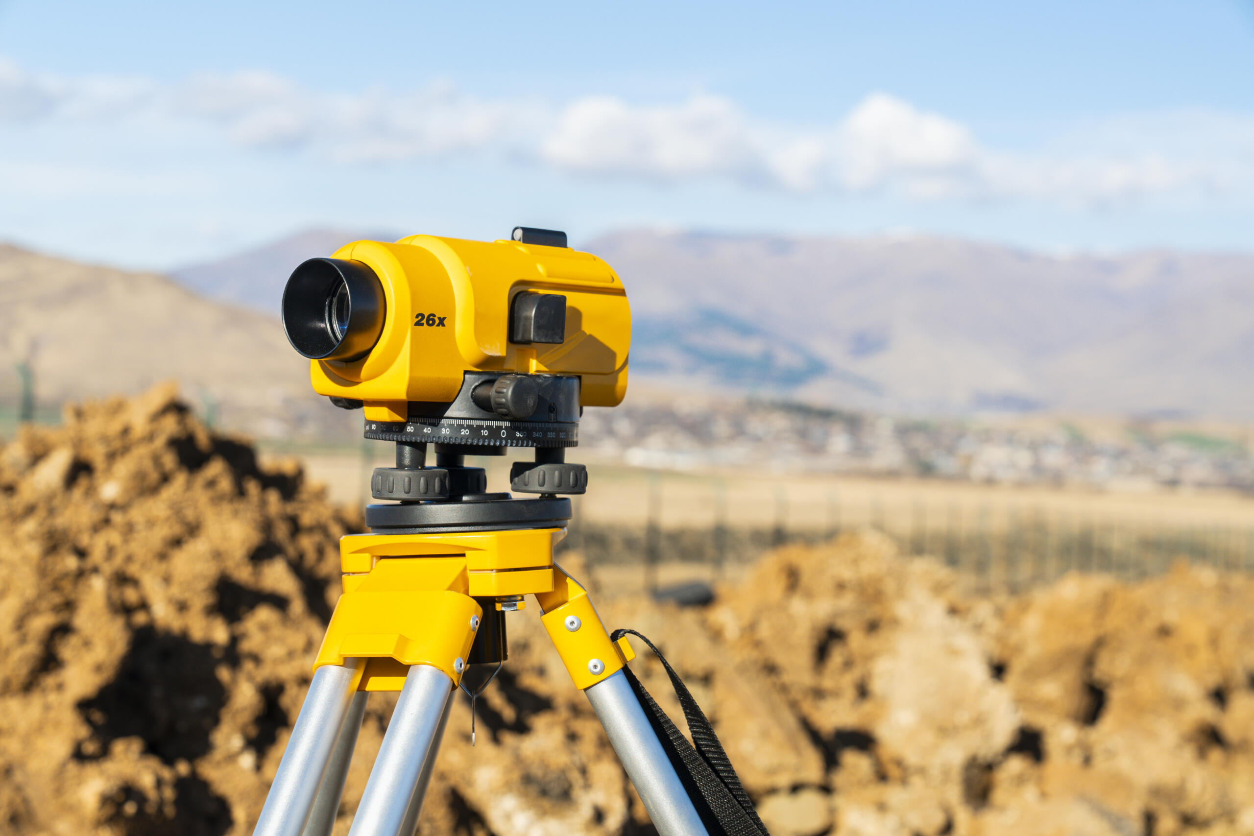 theodolite or total positioning station representing the need to request land survey today