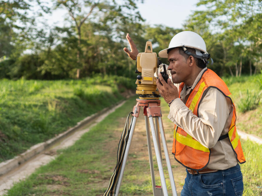 land surveyor at work, symbolizing the need for Professional Commercial Land Survey Services in South Texas