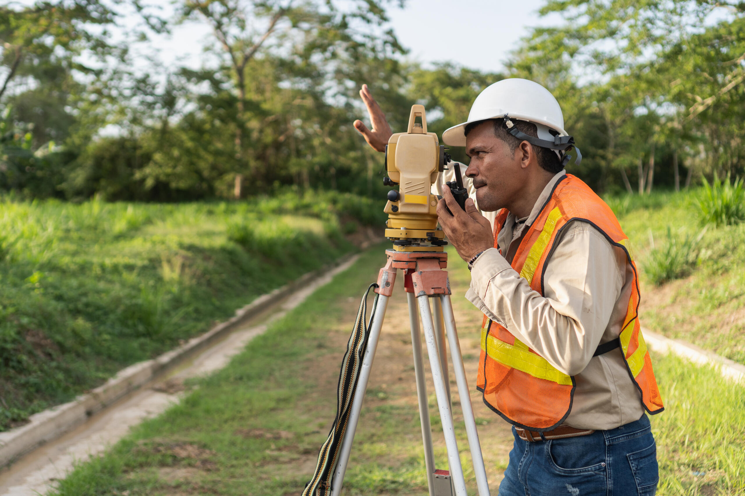 land surveyor at work, symbolizing the need for Professional Commercial Land Survey Services in South Texas