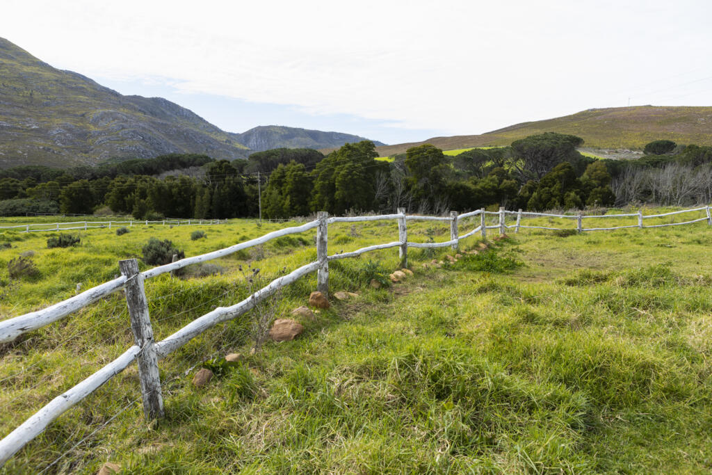 post and rail fence around a field at a farm, representing the importance of Professional ALTA Survey Services