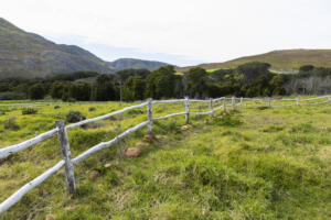 post and rail fence around a field at a farm, representing the importance of Professional ALTA Survey Services