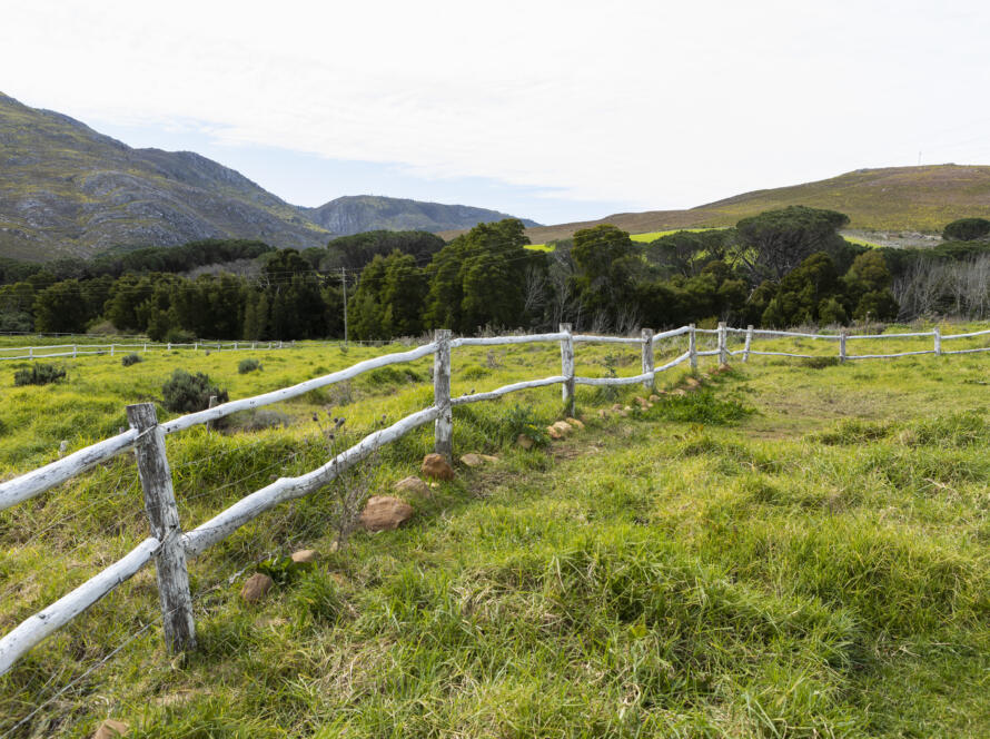 post and rail fence around a field at a farm, representing the importance of Professional ALTA Survey Services