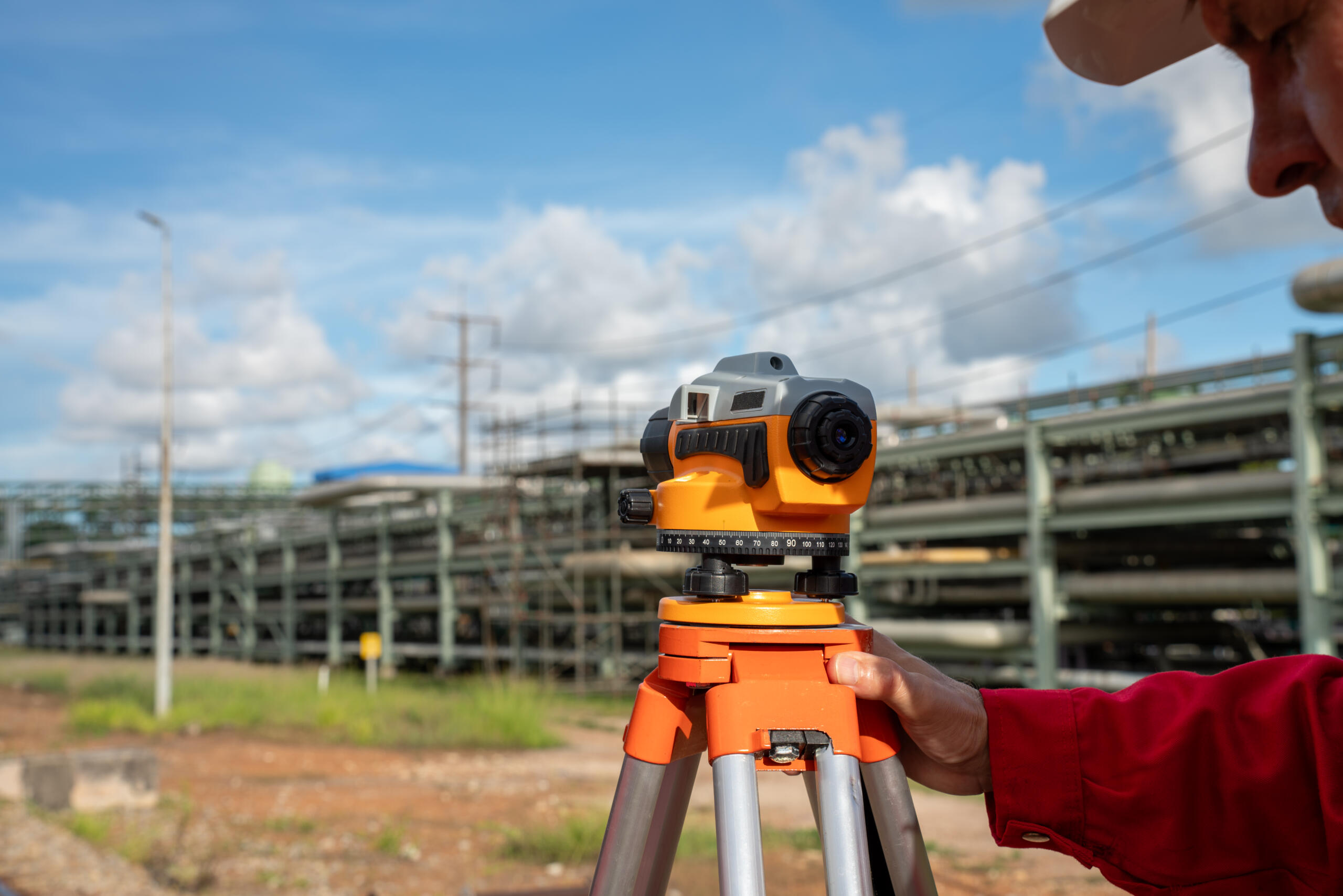 surveyor using optical level tool