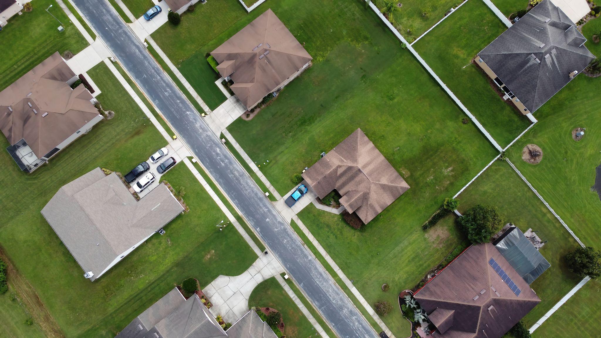 Aerial view of residential lots, homes, fences, and property boundaries