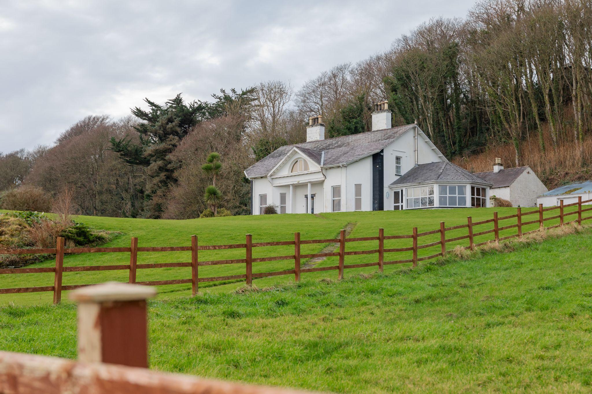 House and fence line showing why property owners may need a boundary survey before making improvements