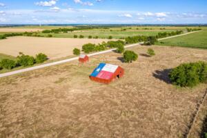 Rural Texas property with farmland and a barn displaying the Texas flag