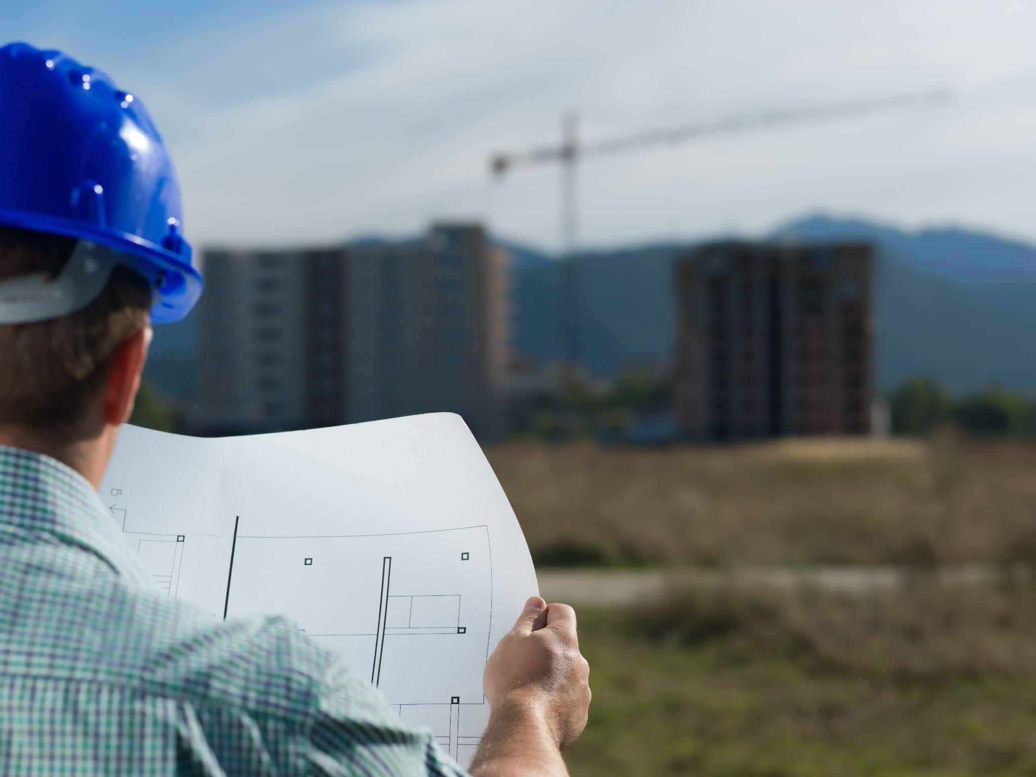 Developer reviewing site plans before beginning a land development project