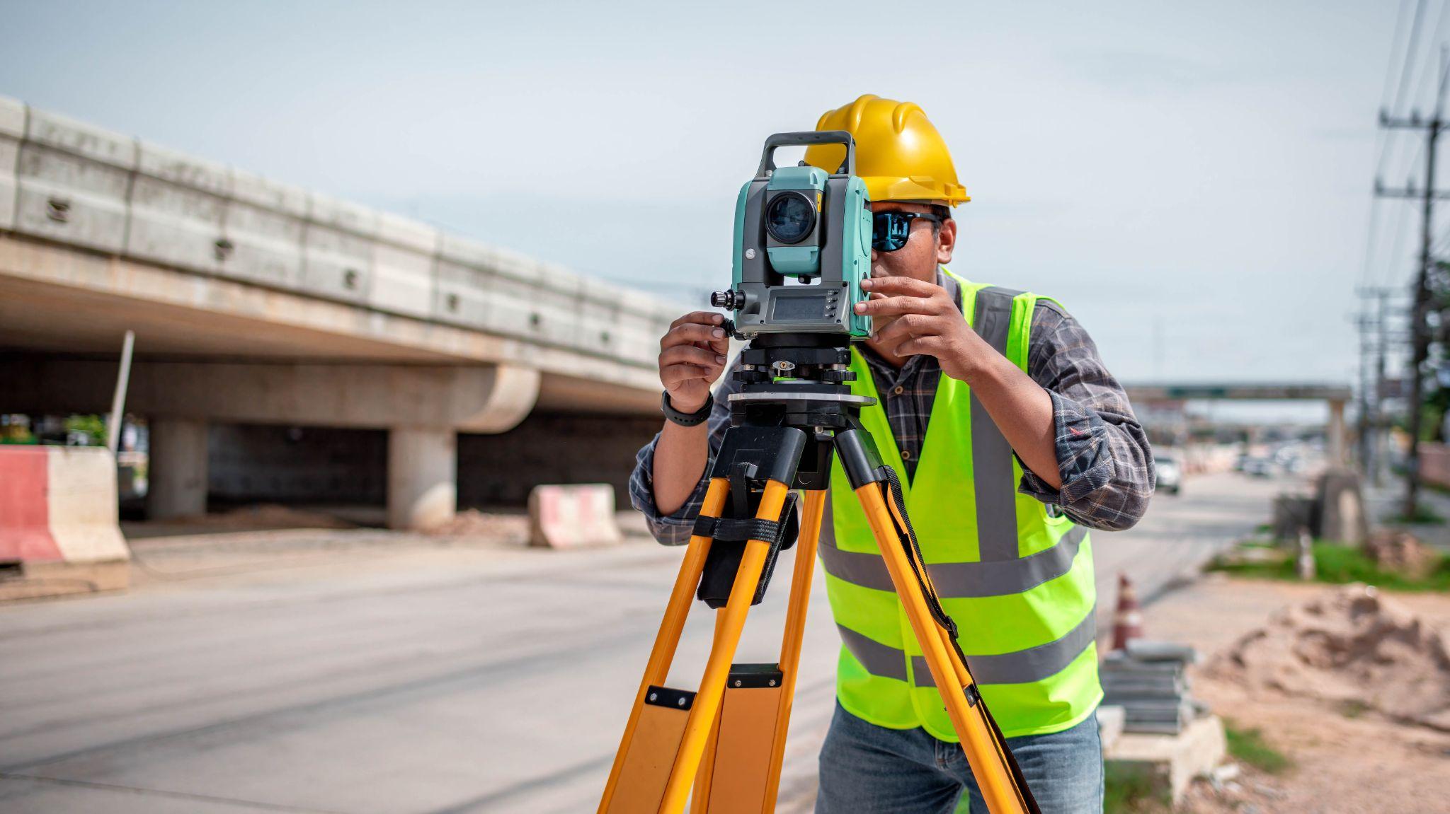 Land surveyor collecting site measurements for a development project