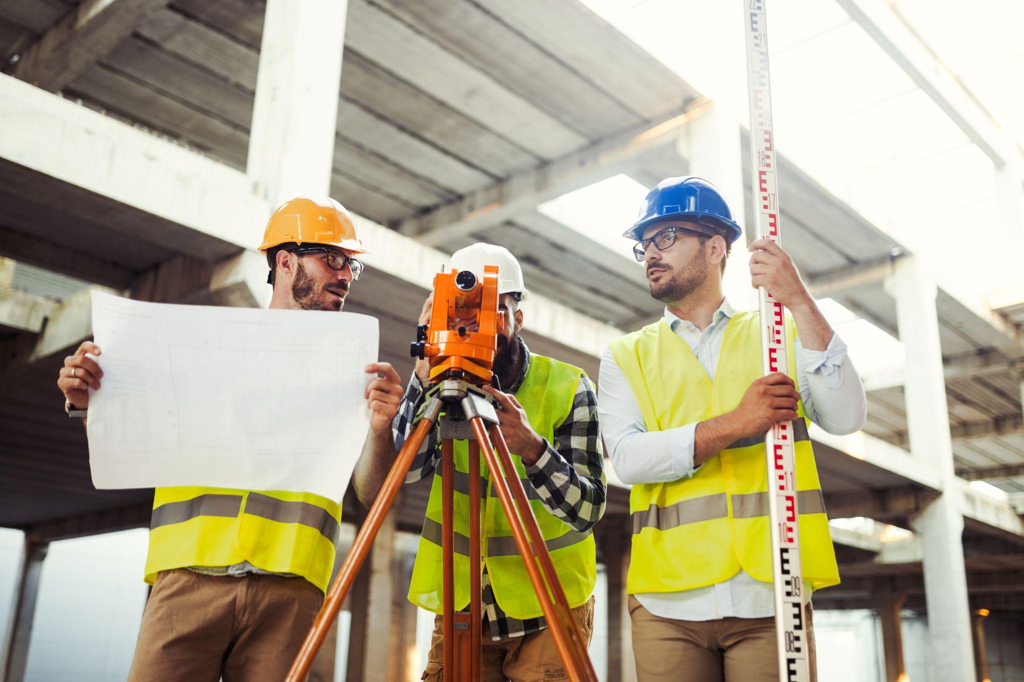 Survey crew performing construction staking at a building development site