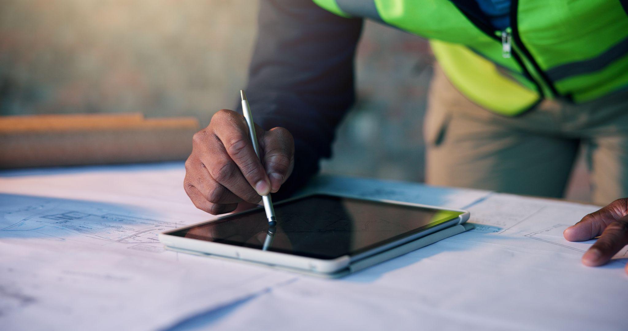 Survey professional reviewing site plans and digital mapping for land development