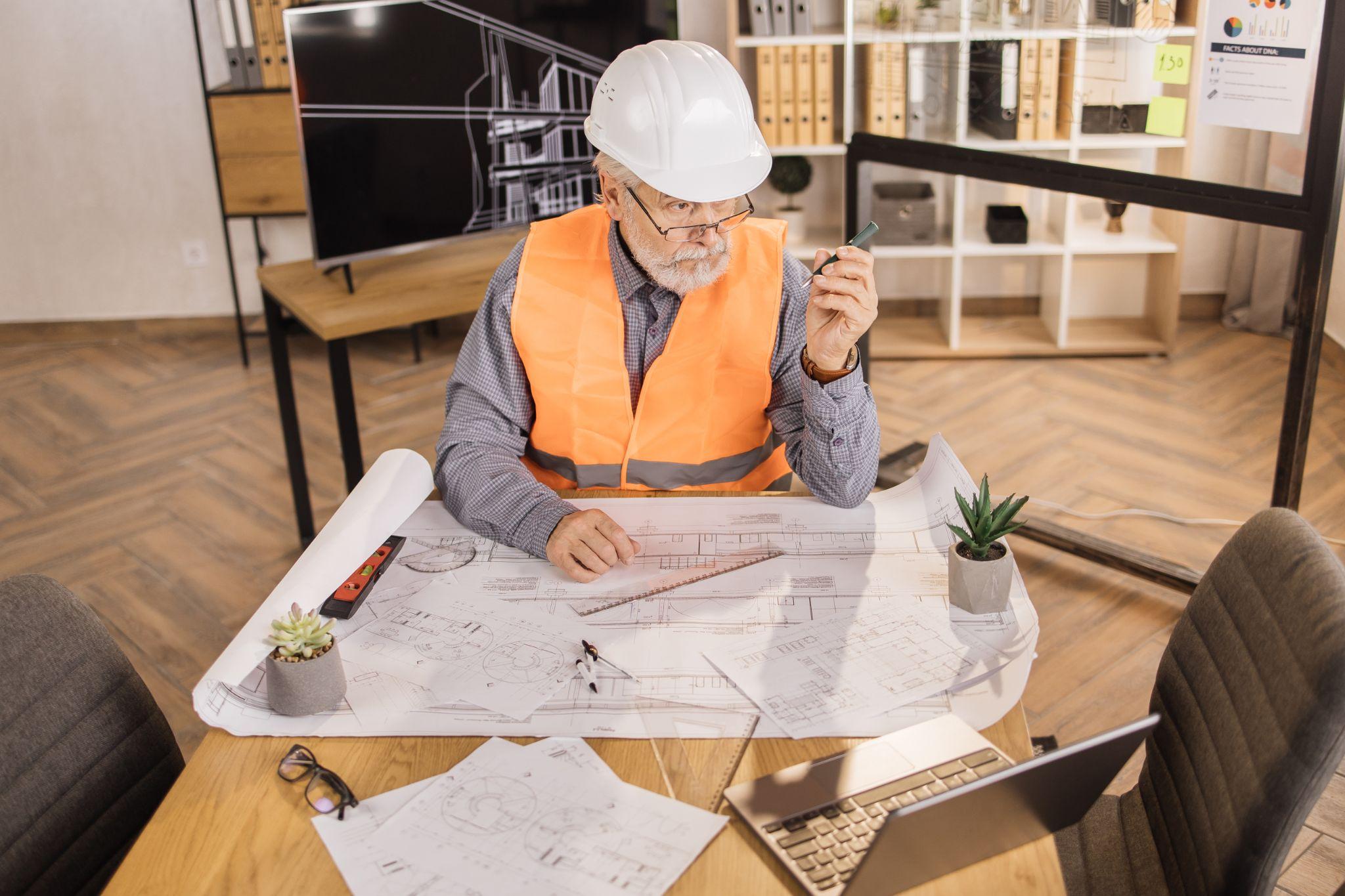 Professional reviewing detailed project plans and technical drawings