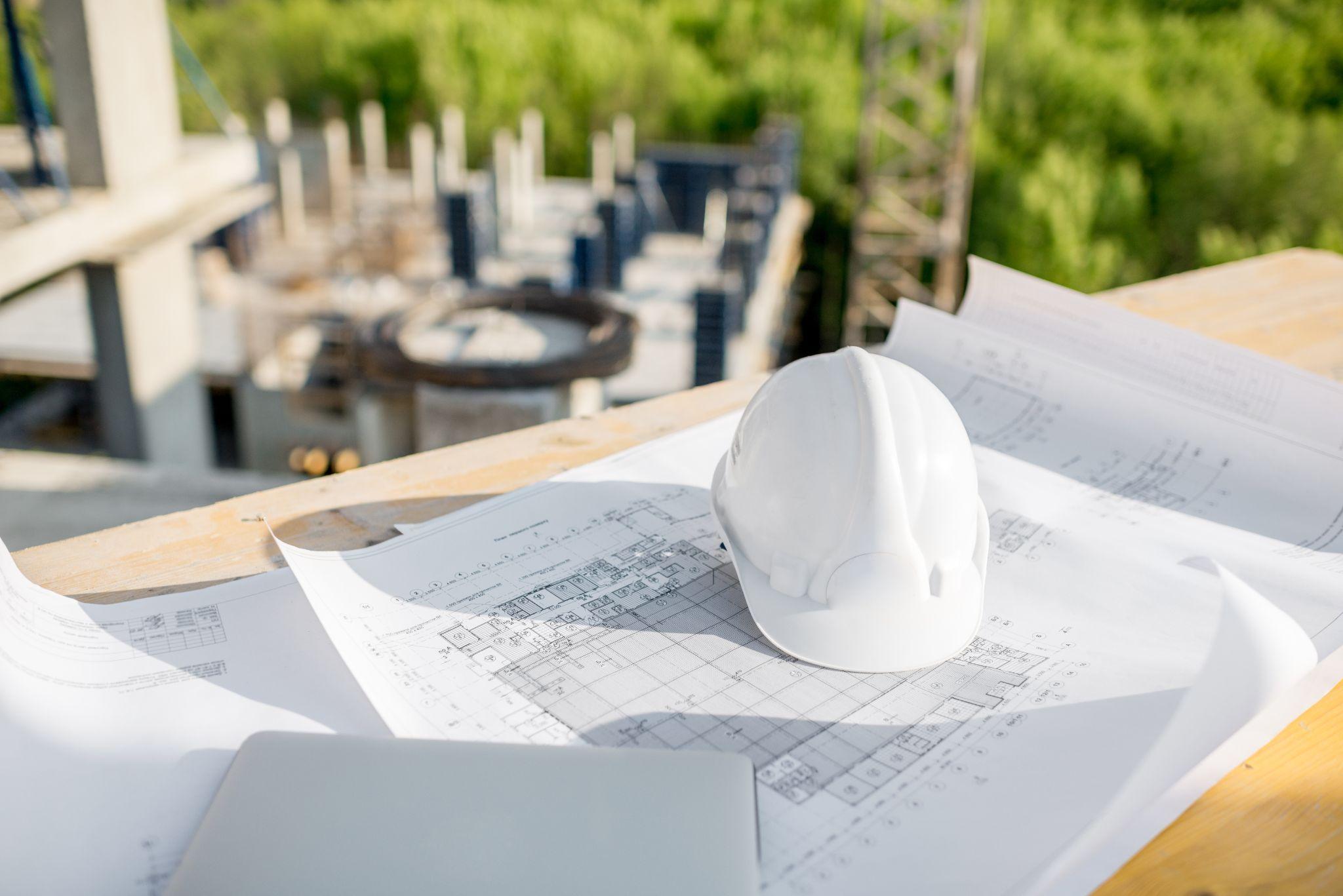 Construction plans and safety equipment prepared for project review