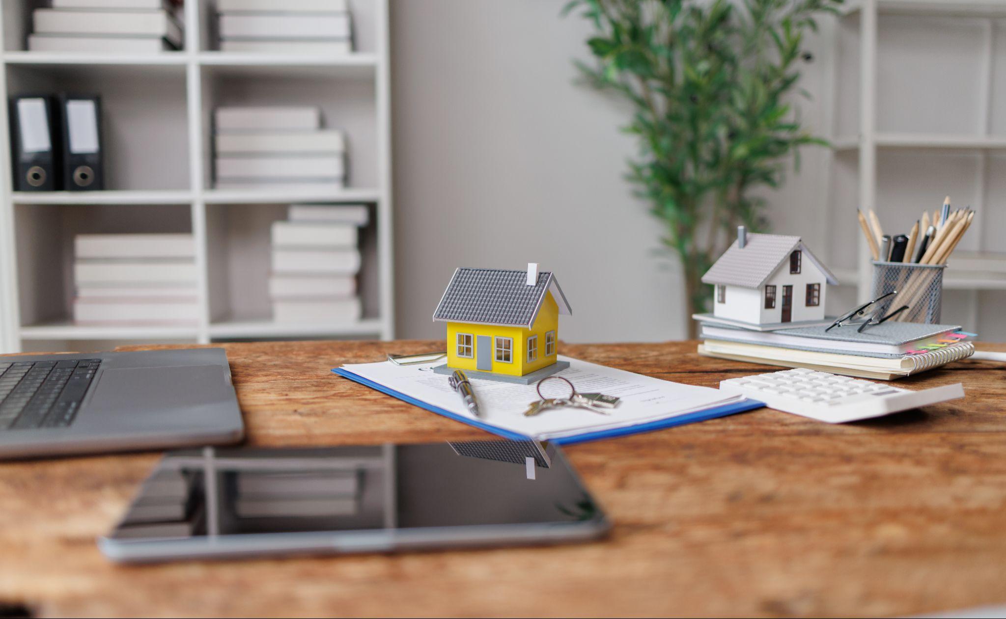 Property documents and model homes representing records used for land survey planning