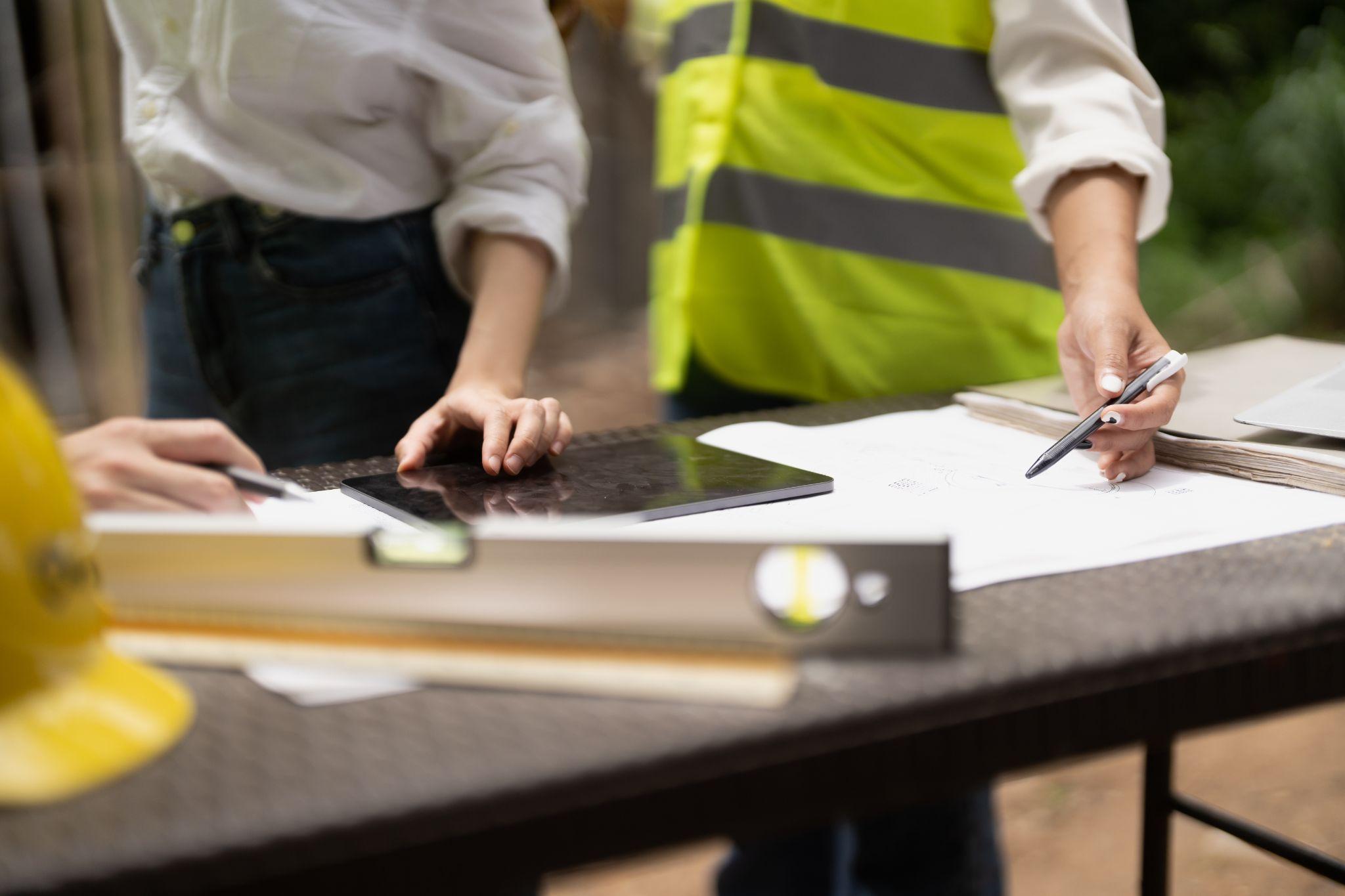 Surveying professionals reviewing site plans and property measurements