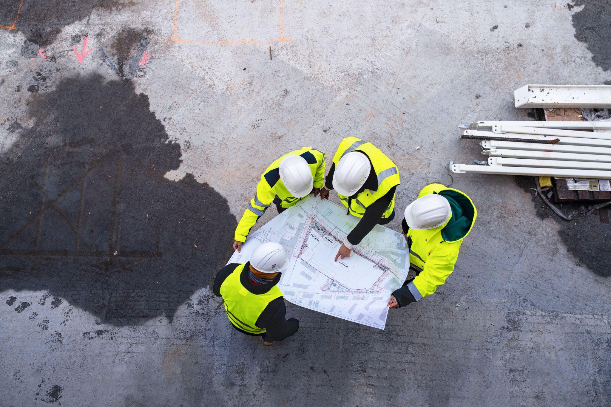 Construction professionals reviewing site plans together