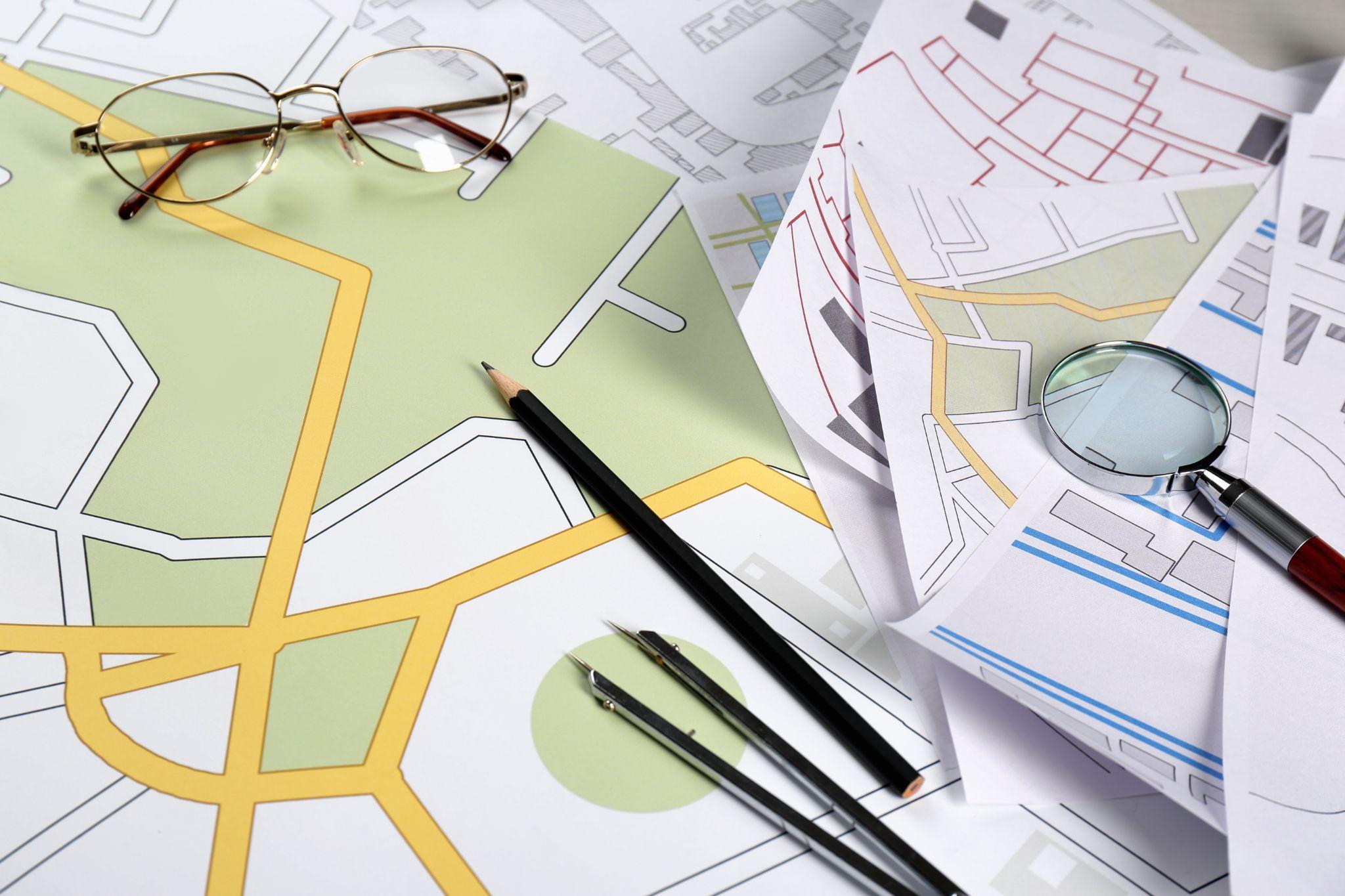 Property maps and planning documents reviewed with measuring tools