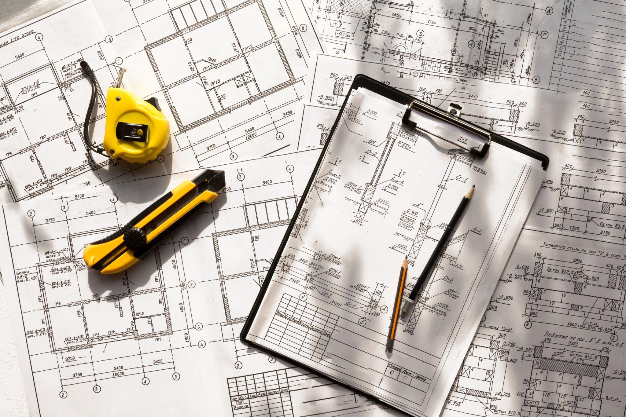 Detailed property plans and measurement tools used for survey documentation