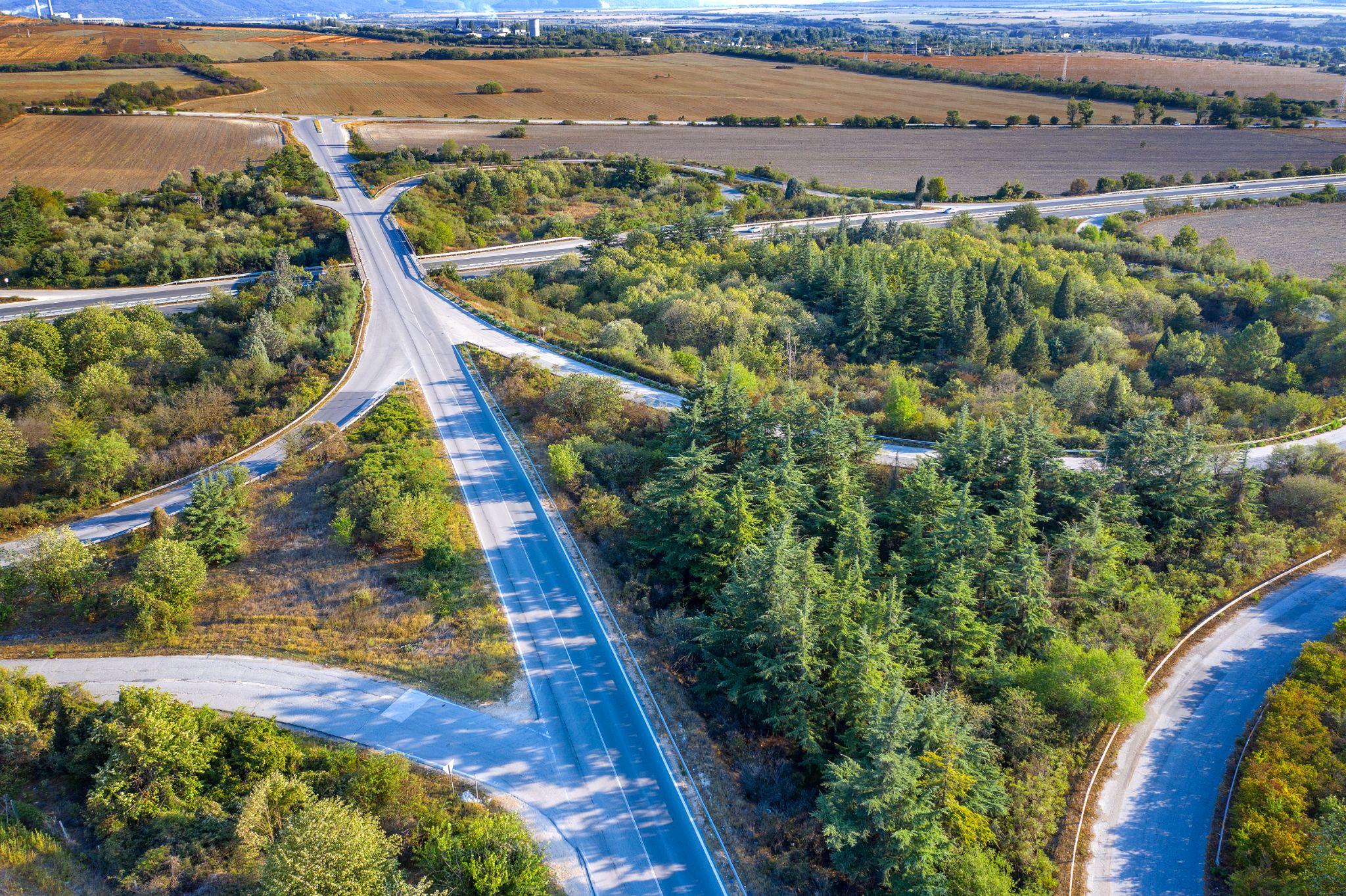 Aerial view of rural property access, homes, and surrounding land